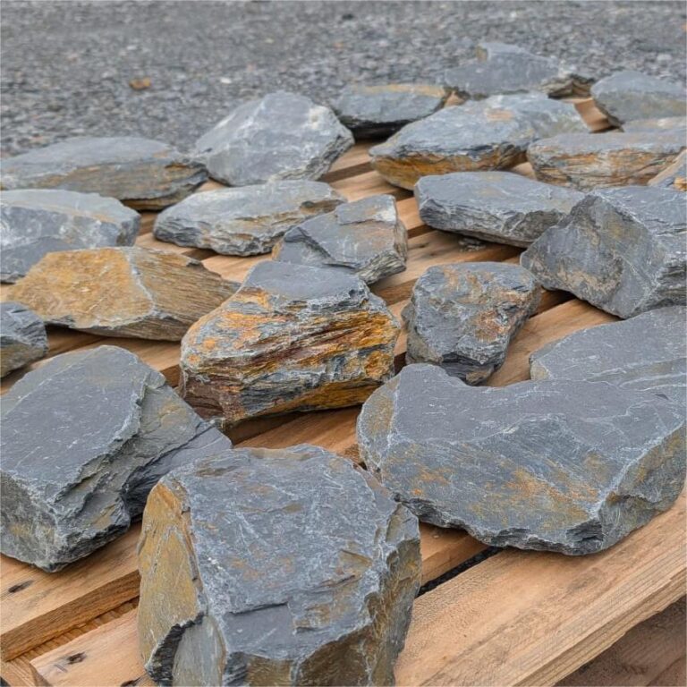 Mini slate pieces spread on a pallet, showing flat faces and layered edges