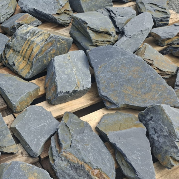 Close-up of dry slate rockery stones showing ochre bands and layered edges