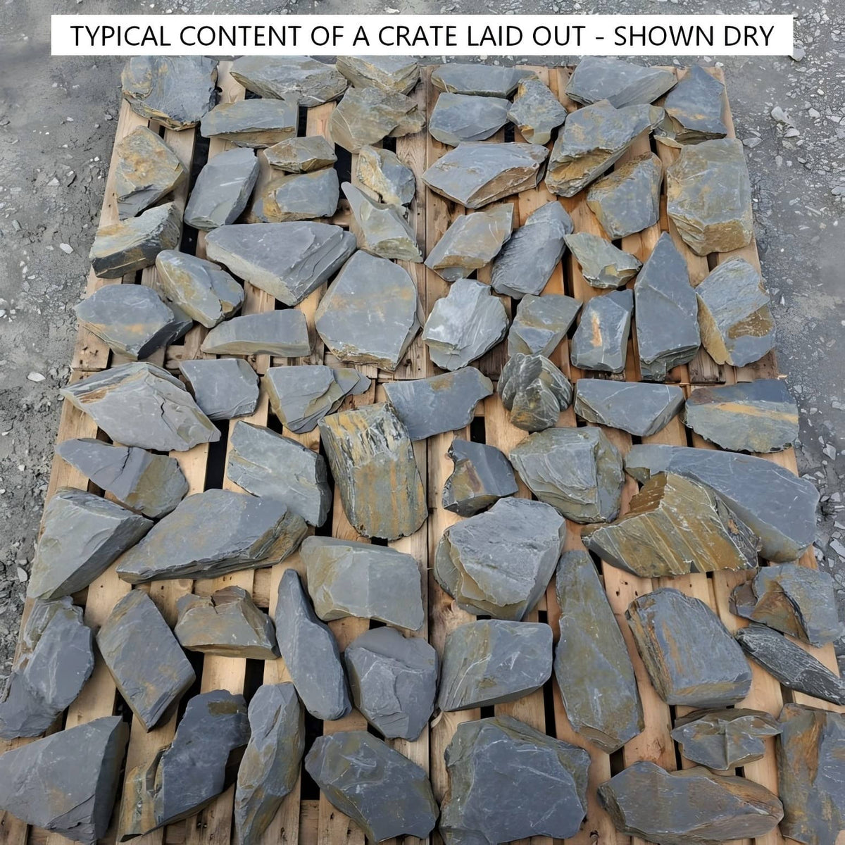 Dry slate rockery stones spread across pallets to show typical crate contents