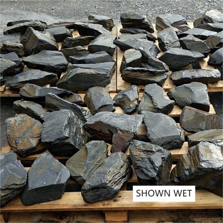 Wet slate stones arranged in rows across wooden pallets