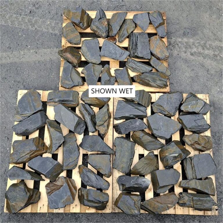 Wet slate rockery stones spread across three wooden pallets