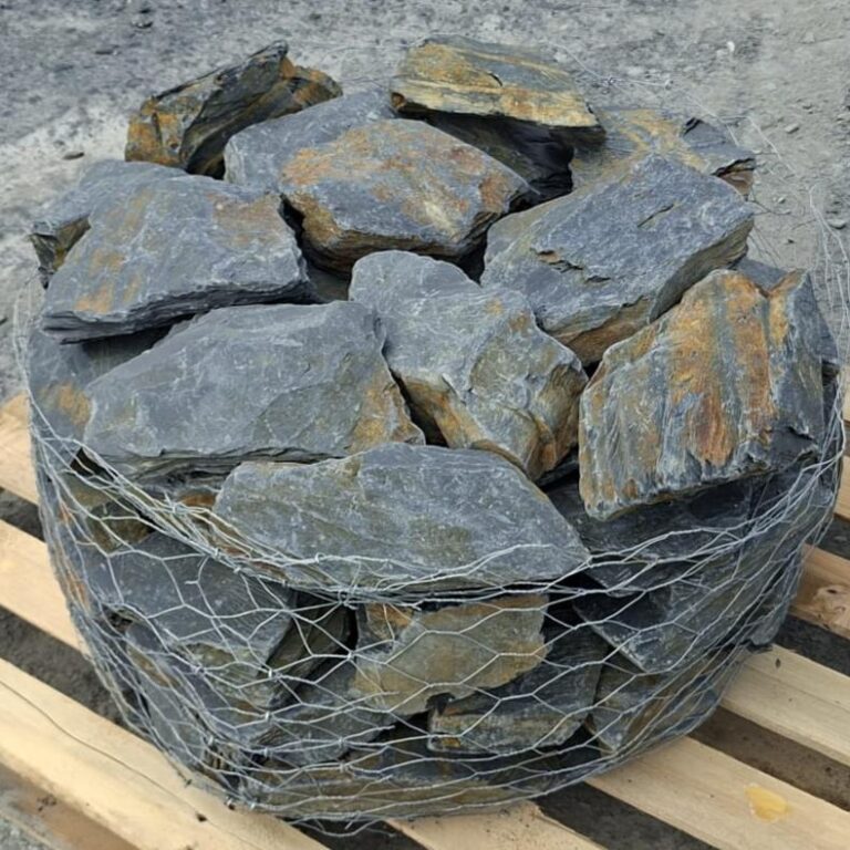 Close-up of stacked slate stones with broad grey faces and rusty edges