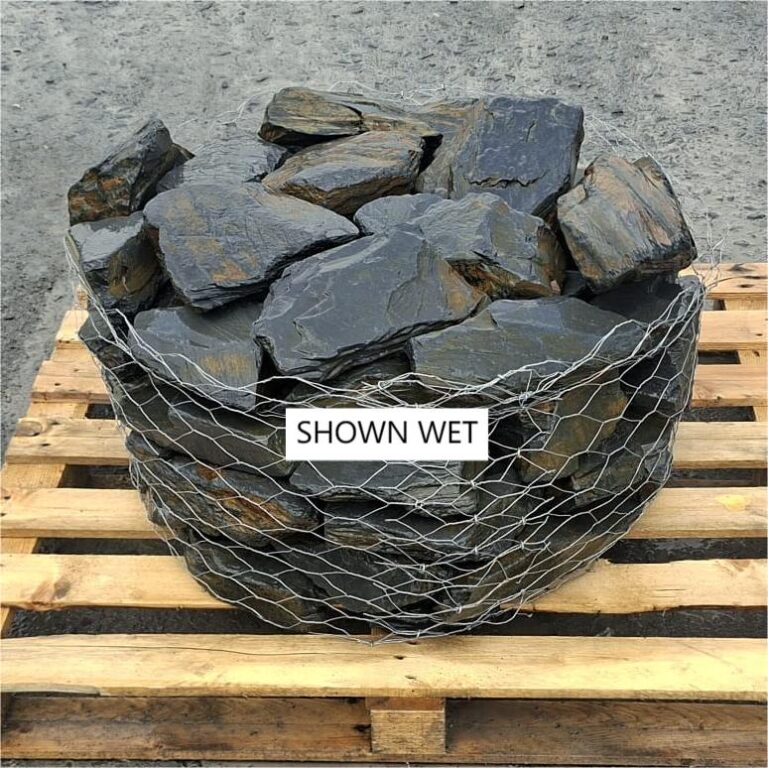 Wire cage filled with wet slate rockery stones on a pallet
