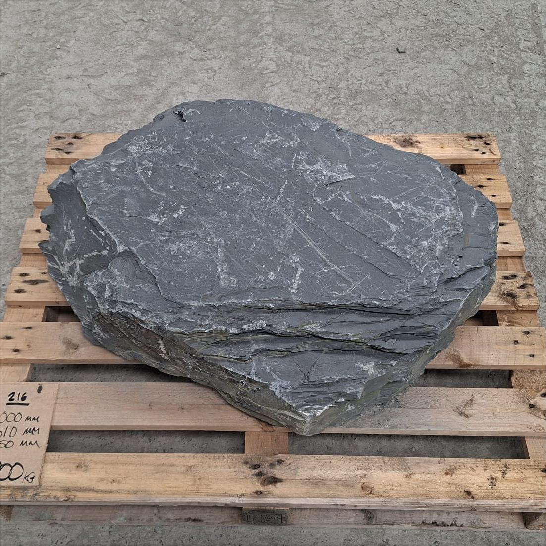 Large flat stone boulder.
